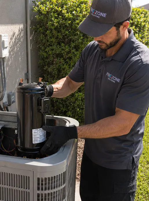 Frozone HVAC technician repairing AC unit at Orlando home